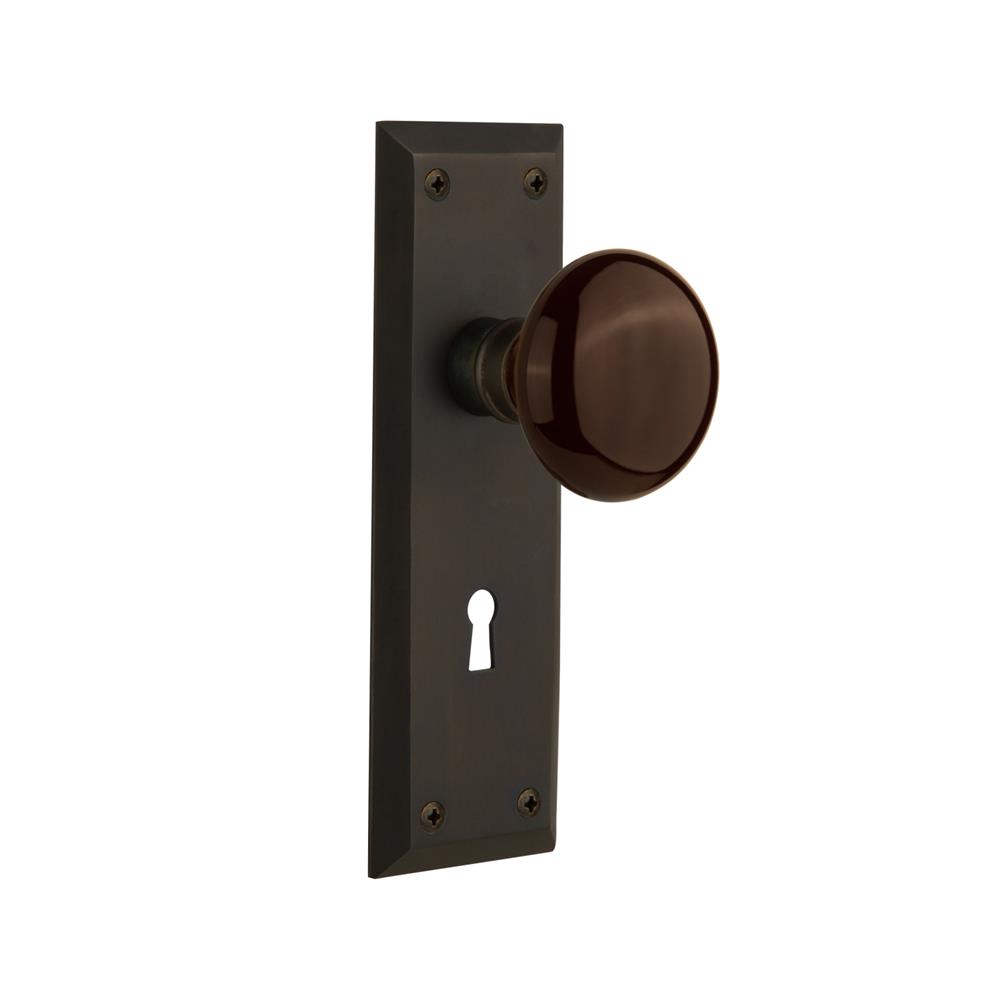 Nostalgic Warehouse NYKBRN Passage Knob New York Plate with Brown Porcelain Knob with Keyhole in Oil Rubbed Bronze